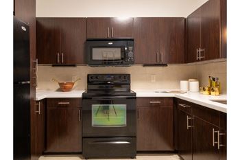 a kitchen with custom cabinetry at The Core apartments